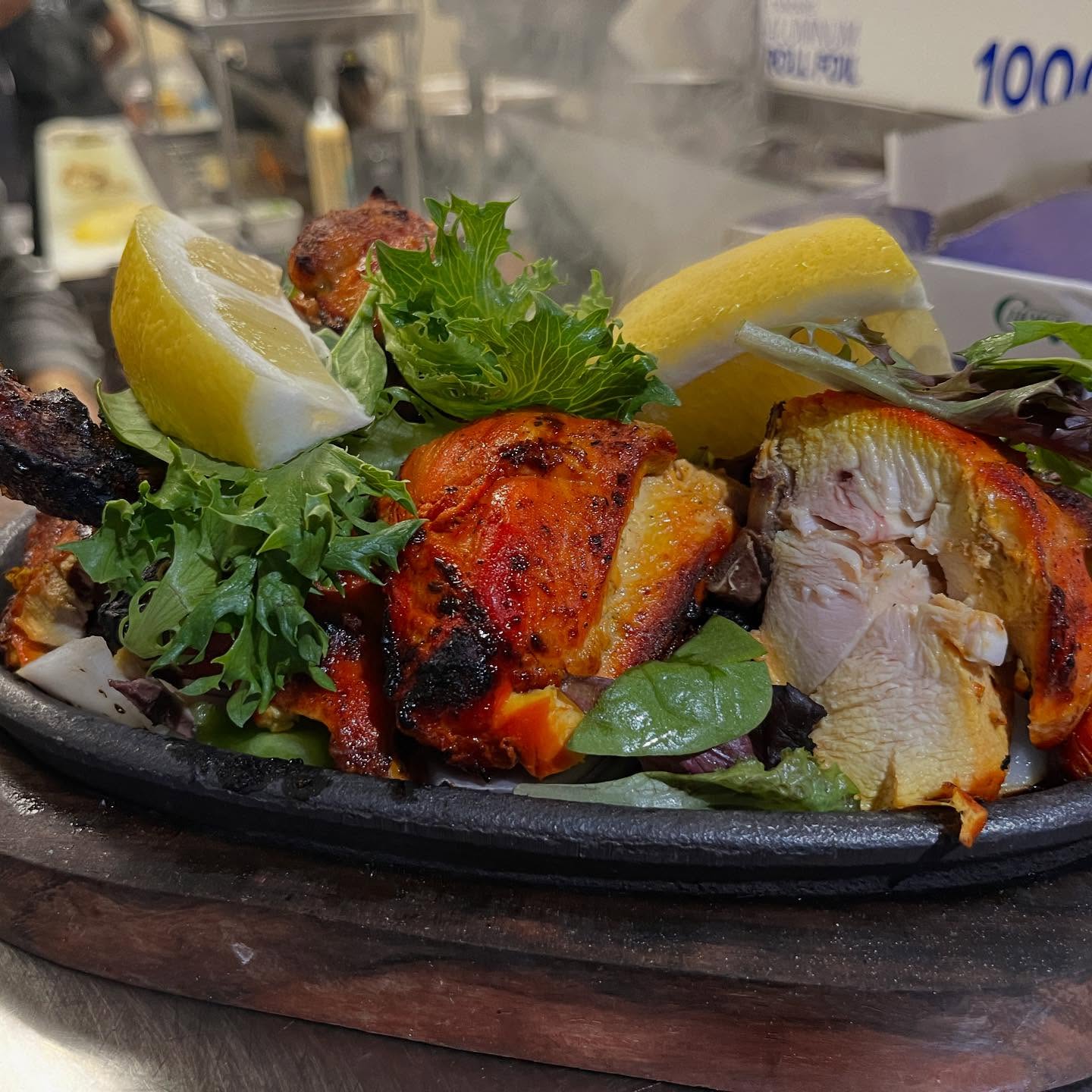 Marinated meat or vegetables cooked in a traditional clay oven, served with naan and chutney.